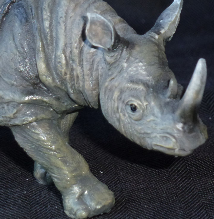 charging rhinoceros statues